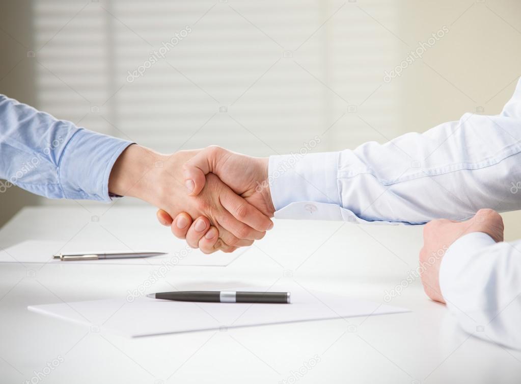 People agreeing terms in a meeting